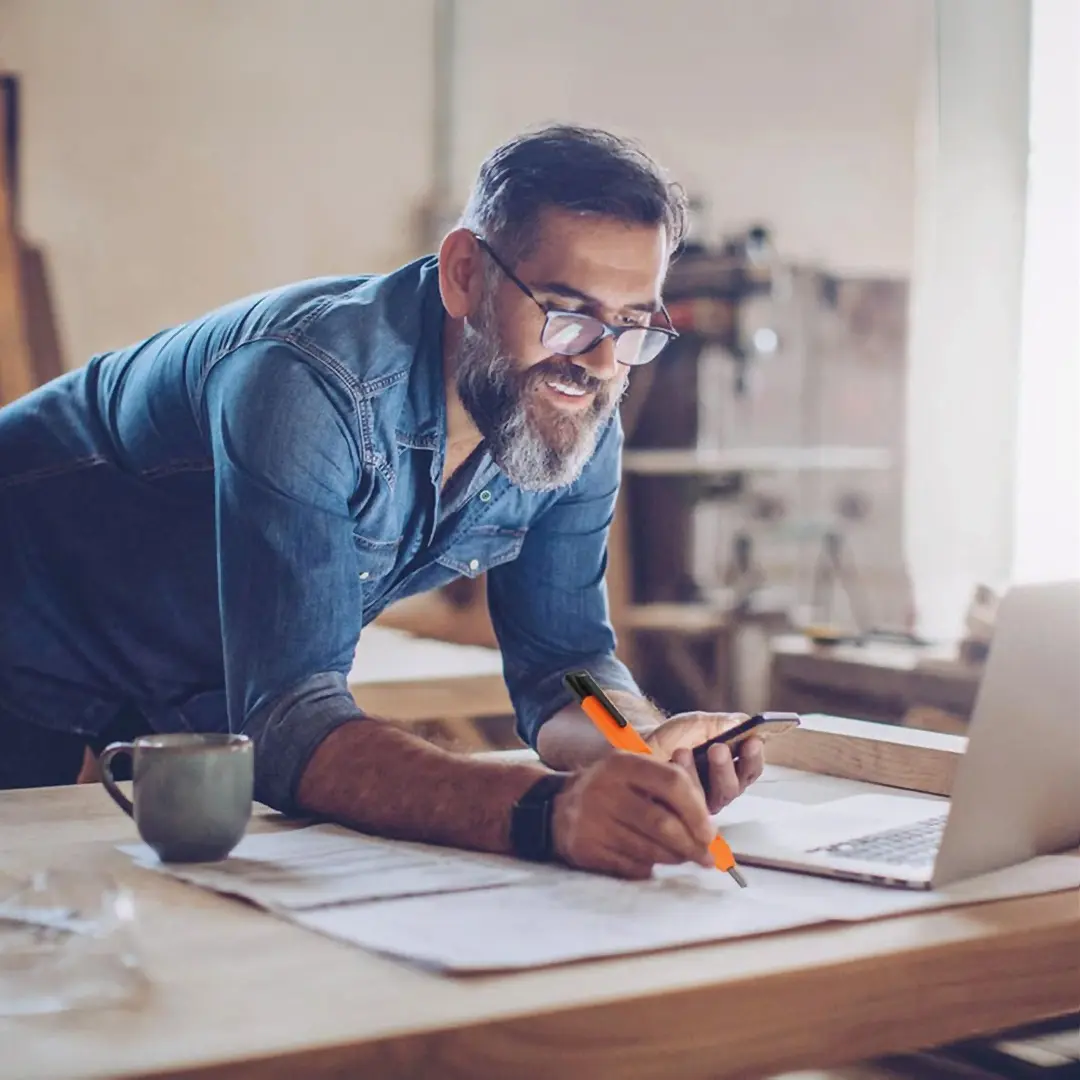 A person writing on page happily