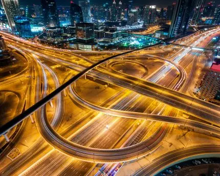 Aerial view of a busy intersection at night in Dubai, UAE